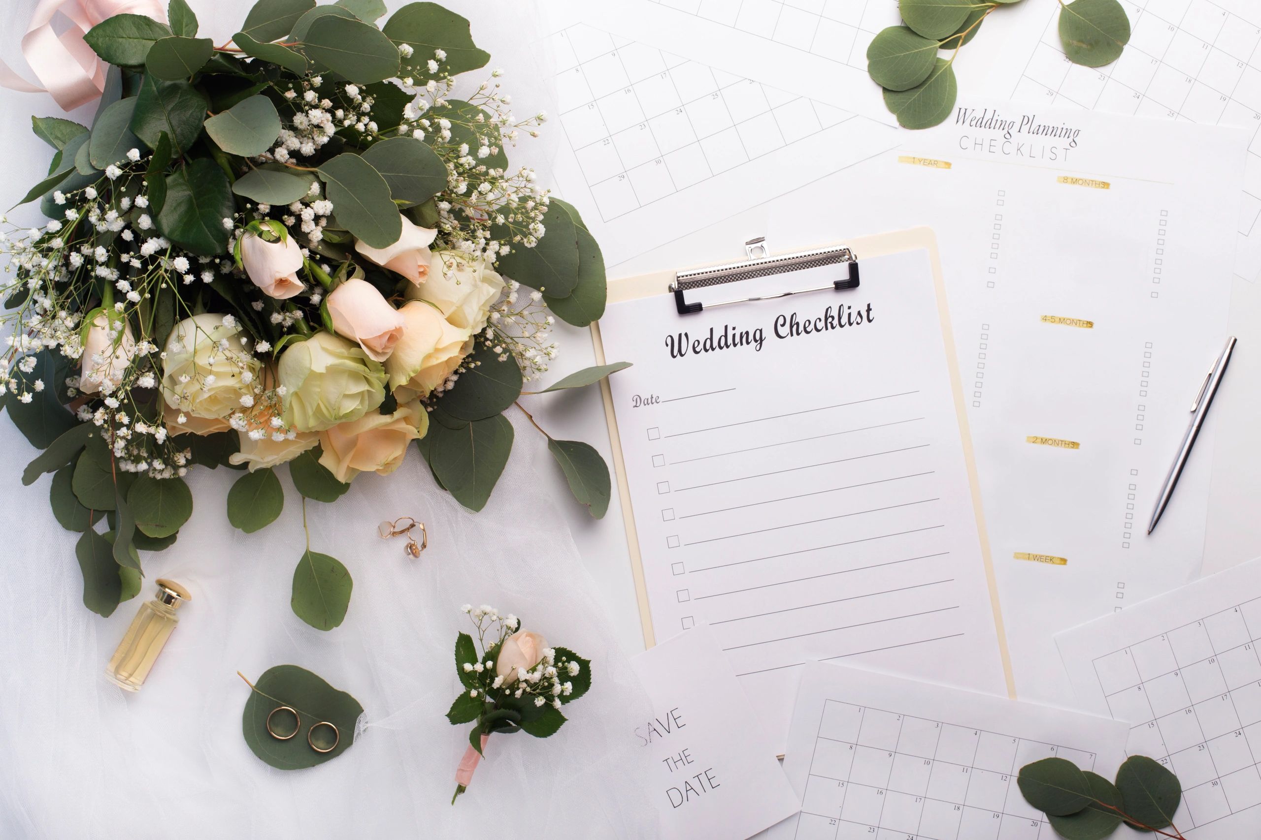 Wedding planning checklist with bouquet on a clean white surface